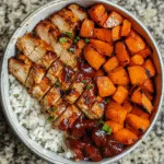 BBQ chicken sweet potato bowl with toppings in a wooden bowl